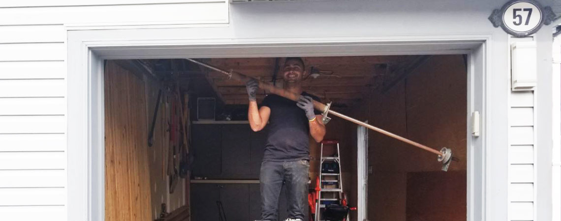 garage door technician installing spring - garage door spring repair mississauga garage door replacement